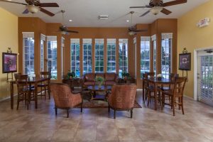 Lounge area with seating and ceiling fans